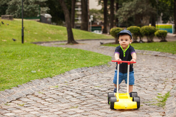 baby with a toy car in a park