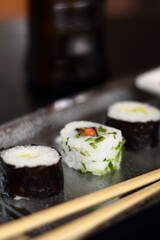 Sushi hosomaki and california maki on metal tray