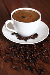 Cup of Coffee and Coffee Beans on wooden plank table
