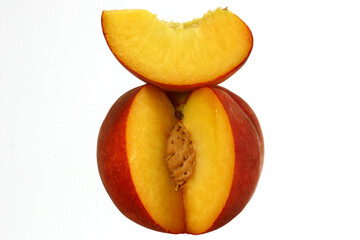 Peach cut with clove and stone, fresh fruit