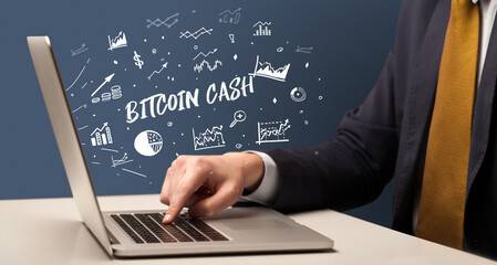 Businessman working on laptop with BITCOIN CASH inscription, modern business concept