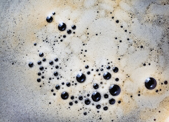 Coffee foam texture. Close-up coffee with bubbles background. Flat lay.