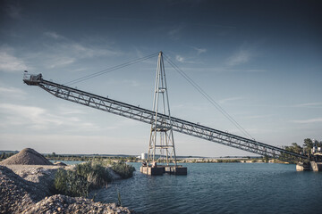 Fototapeta premium Conveyor belt of a gravel extraction installation on water