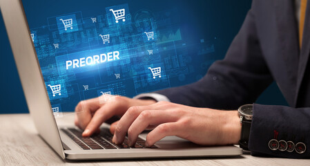 Obraz na płótnie Canvas Businessman working on laptop with PREORDER inscription, online shopping concept