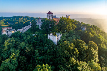 Ruins of medieval Tenczyn castle in Rudno near Krakow in Poland. Aerial view in sunrise light in summer