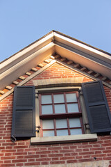 Fototapeta na wymiar Attic Window of a Nineteenth Century Brick House