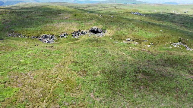 Aerial drone view of the entrance to the historic but remote Chartist Cave in South Wales, UK