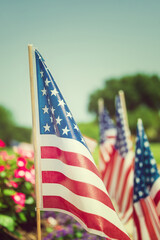 American flags displayed on the side of the street in honor of the 4th of July. Closeup with blue sky background.
