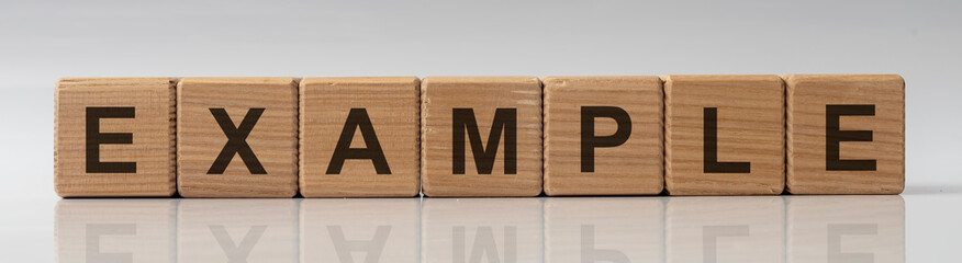 EXAMPLE word written on wooden cube blocks