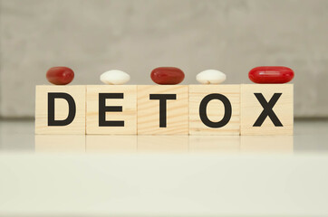  the text detox is written on wooden cubes with tablets on cubes