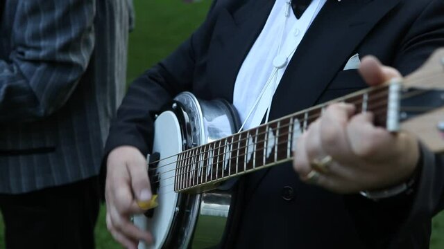 the guitar wedding man playing black. Cinematic wedding clip close up. Save the date shooting