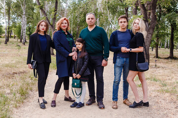 large family of six people in the summer on a walk