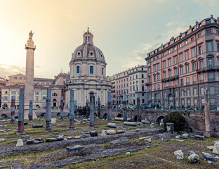 Obraz premium golden hour in Caesar's and Trajan's forum ruins with St.Mary church domes on the babckground, Rome Italy