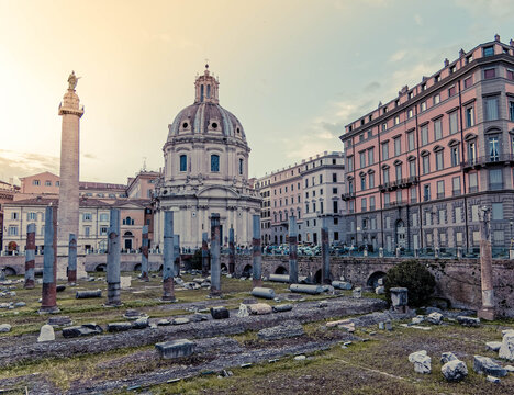 golden hour in Caesar's and Trajan's forum ruins with St.Mary church domes on the babckground, Rome Italy