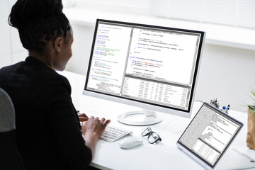African Programmer Or Coder Using Multiple Monitors