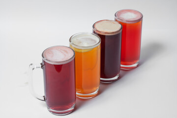 craft and colored beer set in mugs isolated