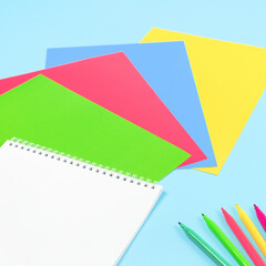color paper, scissors, pencils paint and various school stationery on blue yellow background. Flat lay with copy space for back to school or education and craft concept