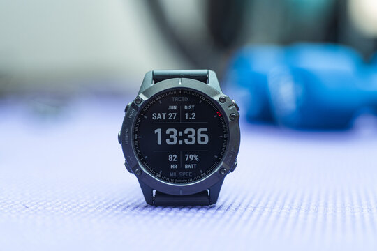 Black smart watch in gym. Using Garmin Fenix 6 Pro fitness tracker in gym. Healthy lifestyle and medicine