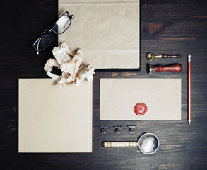 Blank branding identity set on wood table background. Retro stationery template. Top view. Flat lay.