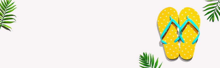 Flip flops with palm leaves- flat lay