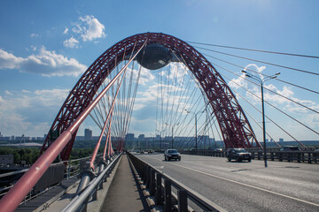 View of the picturesque red bridge serez Moscow river and modern architectural structures on a clear summer day