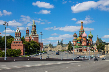 Fototapeta premium Panoramic view of Red square in Moscow with St. Basil's Cathedral and the Kremlin on a clear summer day against a blue sky and space to copy
