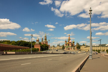 Panoramic view of Red square in Moscow with St. Basil's Cathedral and the Kremlin on a clear summer day against a blue sky and space to copy