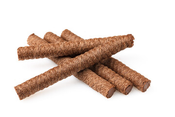 Heap of chocolate waffle rolls isolated on white background with shadows and grit. Close-up