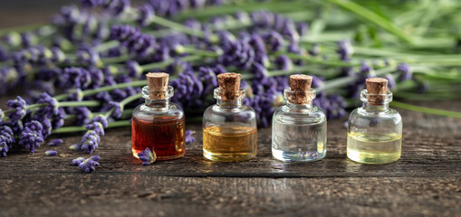 Essential oil bottles with blooming lavender plant