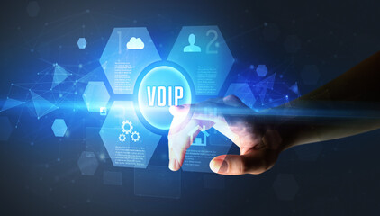 Hand touching VOIP inscription, new technology concept