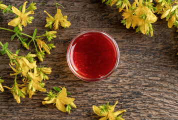 Red oil made from St. John's wort flowers in a bowl