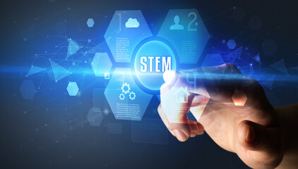 Hand touching STEM inscription, new technology concept