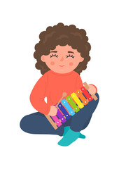 Child playing xylophone. Kids' wooden musical instrument. Children musical and creativity development concept. 