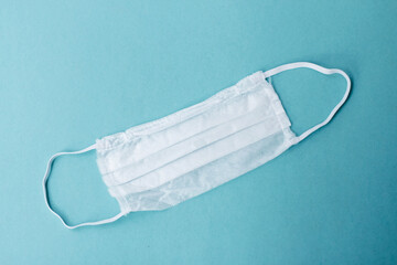 Ear-loop face mask 3 ply, Safety masks on blue background. dust protection respirator and breathing...
