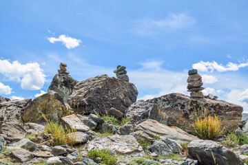 pyramids of stones in the mountains against the blue sky
