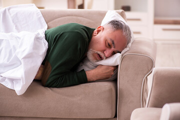 Fototapeta premium Old man suffering at home
