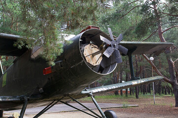 An old military aircraft of the Second World War stands in the park as a monument