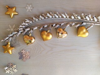 Gold-plated Christmas toys and tinsel on a light blue wooden background