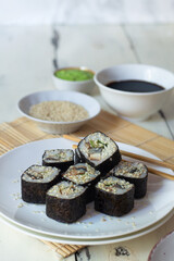 Sushi rolls with eel, sesame, cucumber and wasabi 