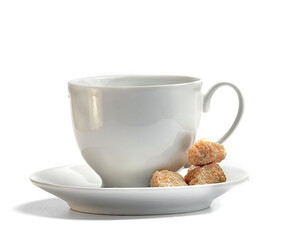 white coffee cup with saucer and brown cane unrefined sugar on a white background
