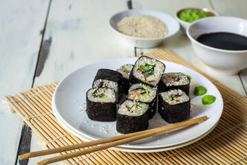 Sushi rolls with eel, sesame, cucumber and wasabi 