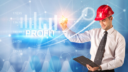 Young businessman with helmet drawing PROFIT inscription, modern business technology concept