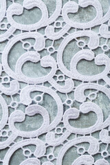 The texture of lace on a rustic background. Close up. Top view.