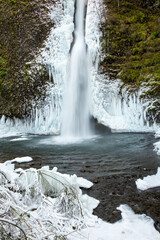 Horsetail falls  after a winter snow and ice storm.  The falls is in the Columbia River Gorge National Scenic Area, about 18 miles east of Portland, Oregon.