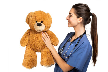 Beautiful nurse holding a teddy bear, pediatrician concept