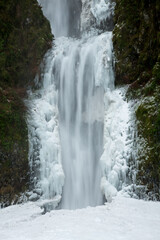 Multnomah Falls after a winter snow and ice storm.  The falls is in the Columbia River Gorge National Scenic Area, about 18 miles east of Portland, Oregon.