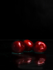 red apples on black background