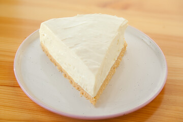 classic cheesecake on white plate on  wooden table