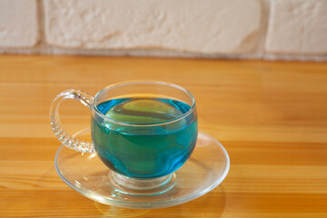 Crystal cup with green tea on table