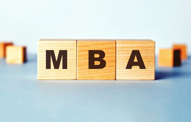 The abbreviation MBA is written on wooden cubes.